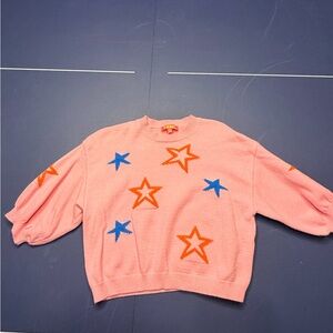 Mira Mikati Pink Sweater with Orange and Blue Stars
